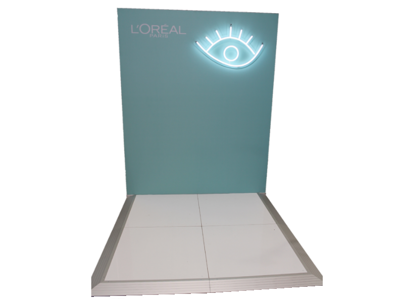 Small booth backdrop with custom lighting feature mounted to frame